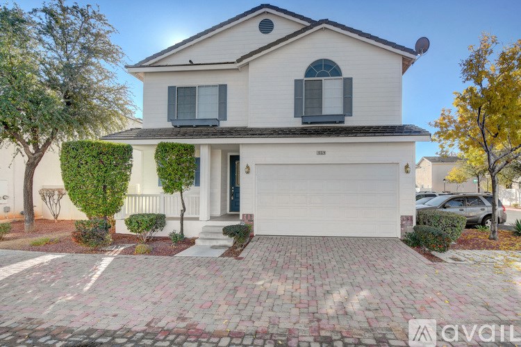 A house with a garage and a driveway in front.