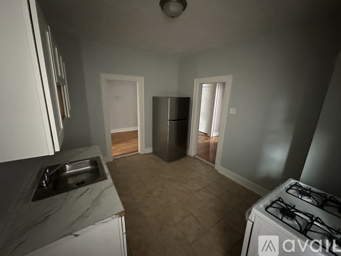 A kitchen with a white fridge and a white stove.