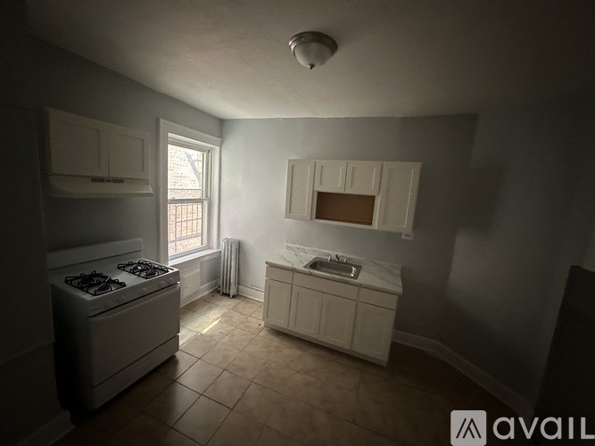 A kitchen with a stove and a window.