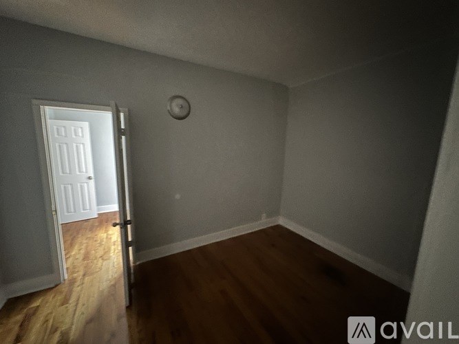 A room with a door and a clock on the wall.