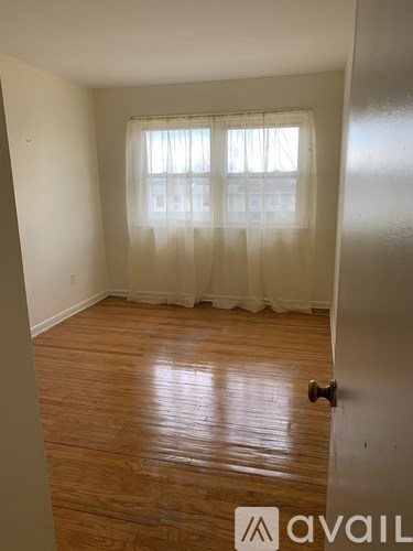 A white bathtub with a shower door and a shower curtain.