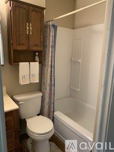 A room with a ceiling fan and a tiled floor.