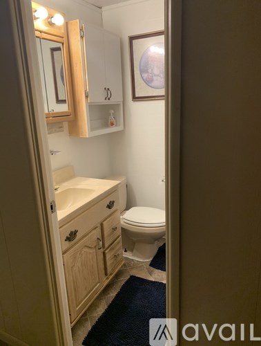 A room with a ceiling fan and tiled flooring.