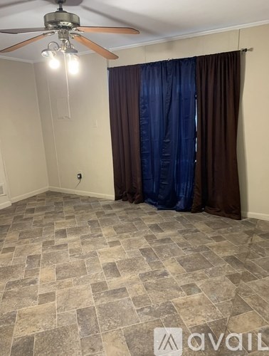 A room with a tiled floor and a white door.