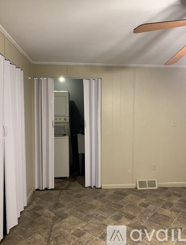 A room with a ceiling fan and a tiled floor.