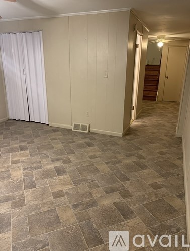 A concrete staircase leads up to a balcony with a metal railing.