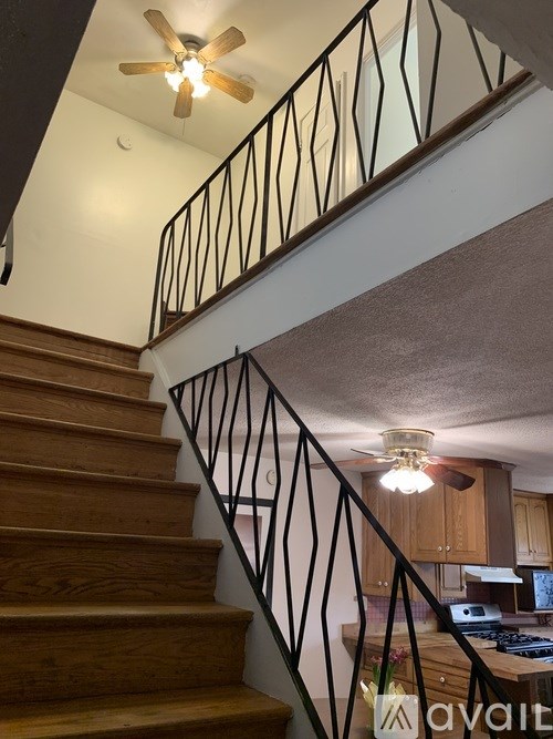 A staircase with wooden steps and a metal railing.