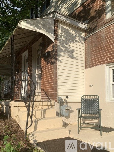 A house with a chair and a mailbox.