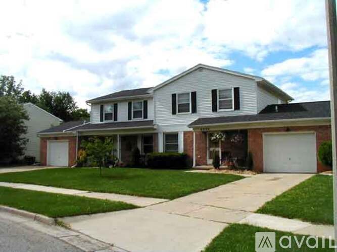 A two-story house with a garage is for sale.