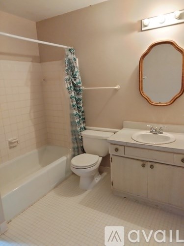 A bathroom with a toilet, sink, and bathtub.
