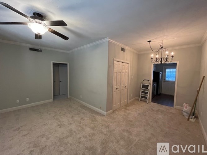 A room with a ceiling fan and a chandelier.