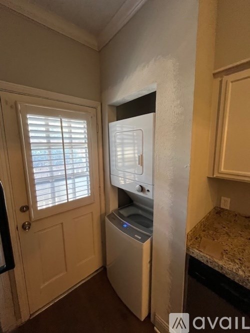 A small white fridge in a kitchen corner.