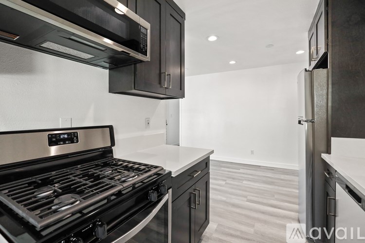 A modern kitchen with a stainless steel oven and microwave.