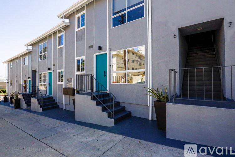 A building with a blue door and windows with shutters.