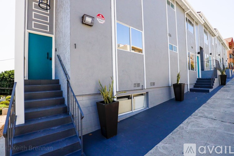 A building with a blue door and a red and white sign on the wall.