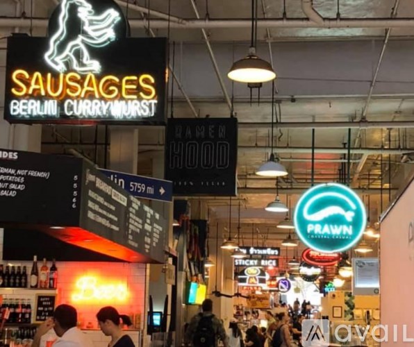 A sign for Sausages Berlin Currywurst hangs from the ceiling.