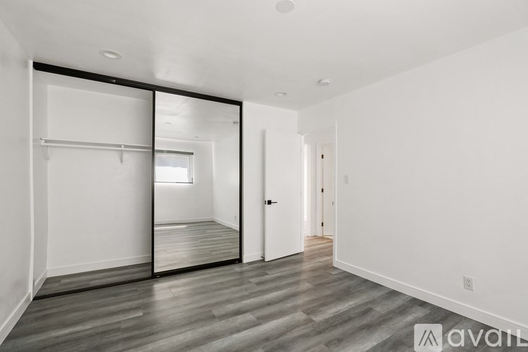 A room with a sliding door and a wooden floor.