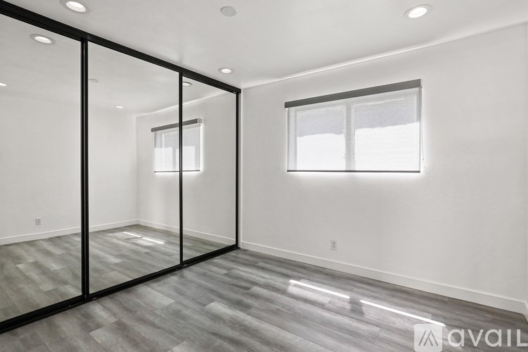 A spacious room with a glass door and a window.