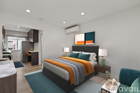 A bedroom with a large bed and a chair.
