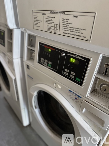 A front load washing machine with a digital display showing the time as 5:00.