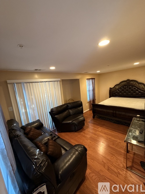 A hallway with a rug on the floor and a ceiling fan.
