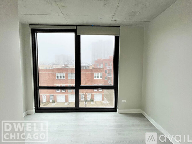 A room with a large window overlooking a building.