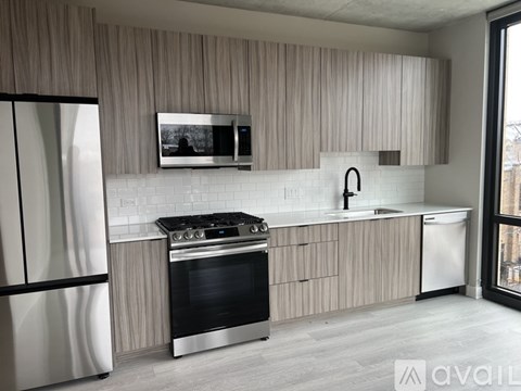A modern kitchen with a stainless steel oven and microwave.