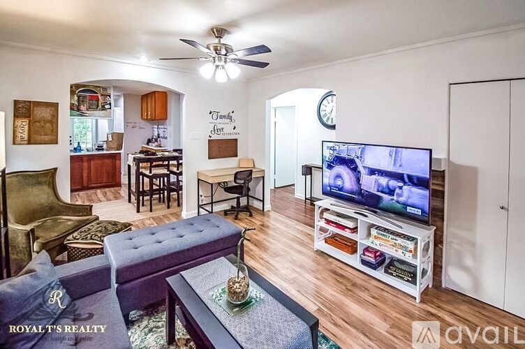 A living room with a flat screen TV and a sofa.