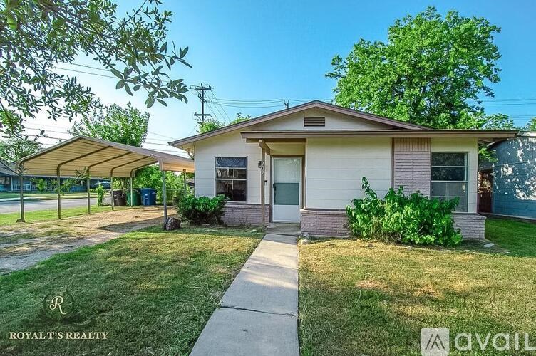 A house with a white and beige exterior is for sale.