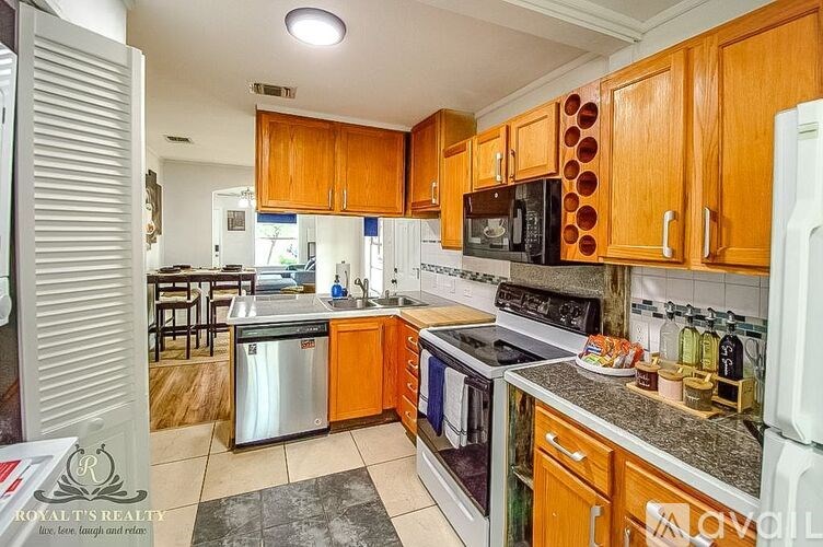 A kitchen with wooden cabinets and a white refrigerator.