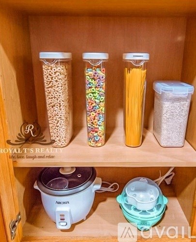 A kitchen pantry with a rice cooker and a container of pasta.
