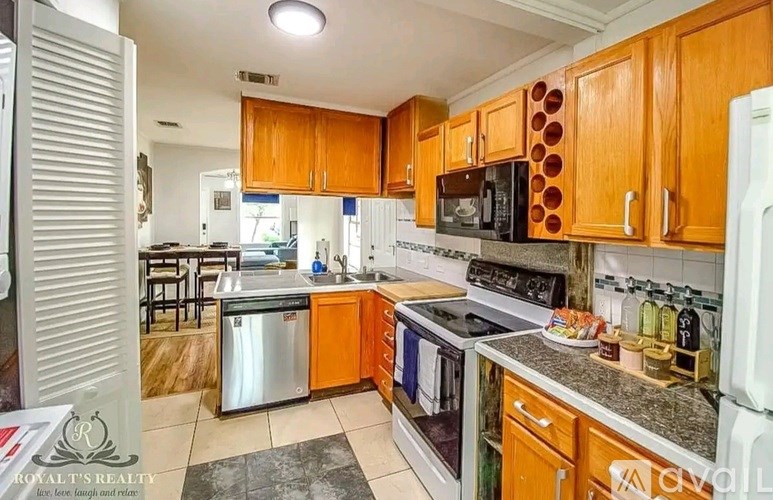 A kitchen with wooden cabinets and a white refrigerator.