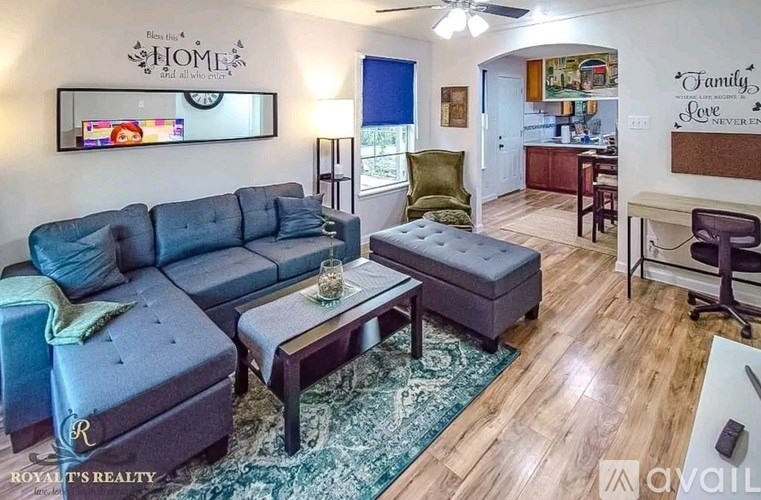 A living room with a grey sofa and a coffee table.