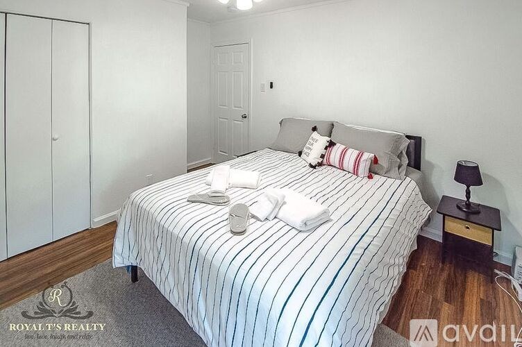 A bedroom with a bed, nightstand, and wardrobe.