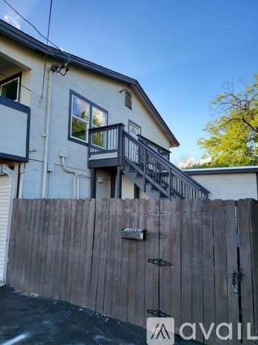 A house with a wooden fence and a balcony.