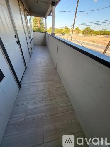 The image shows the interior of a vehicle with a tiled floor and a view of the outside through the windows.