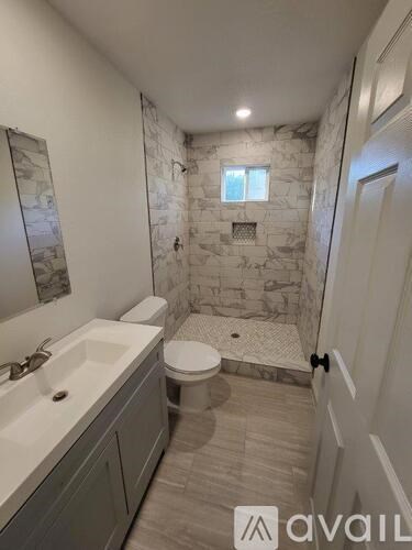 A bathroom with a stone wall and a toilet.