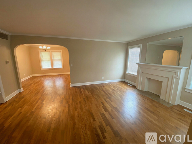A room with wooden floors and a fireplace.