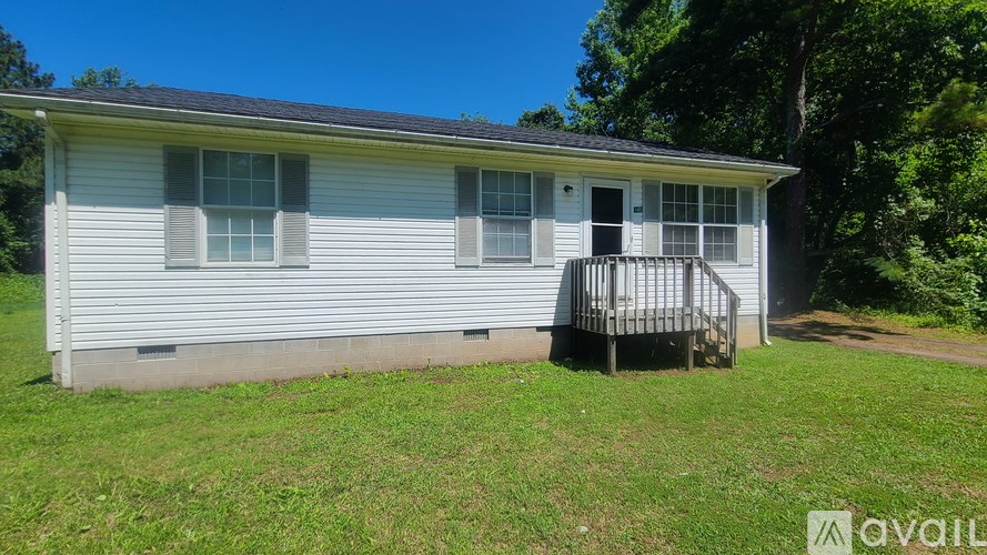 A small house with a porch and a covered patio is for sale.