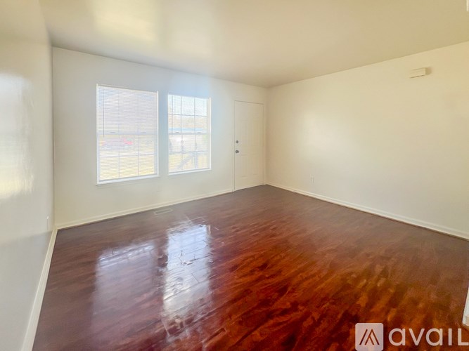 Empty room with wooden floors and a window.