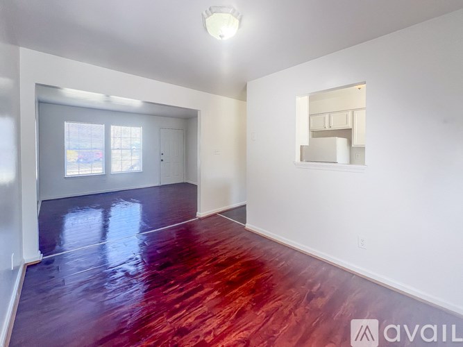 A room with a red floor and white walls.