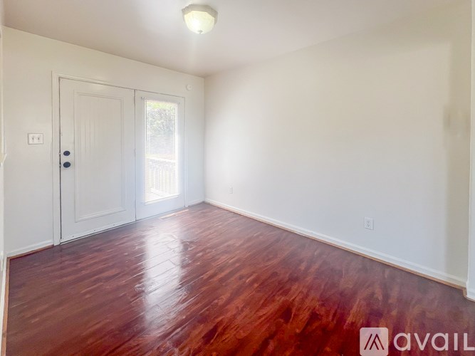 A room with wooden floors and white walls.