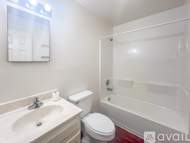 A bathroom with a sink, toilet, and bathtub.