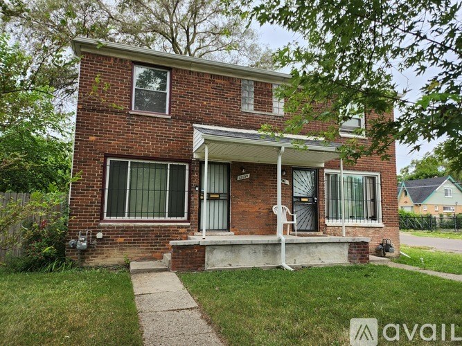 A brick house with a porch and a white door.