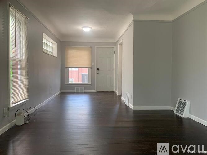 A room with wooden floors and white walls.