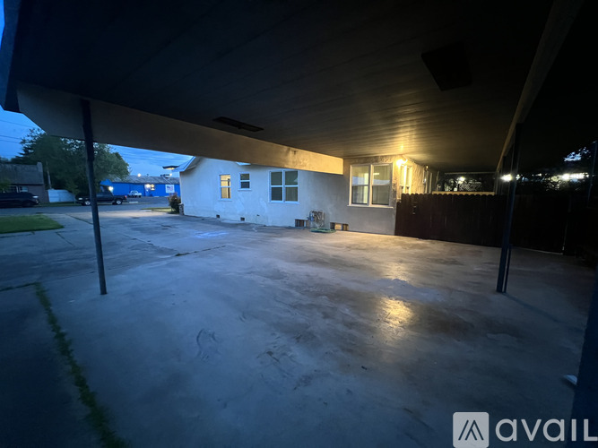 A parking lot with a white building in the background.