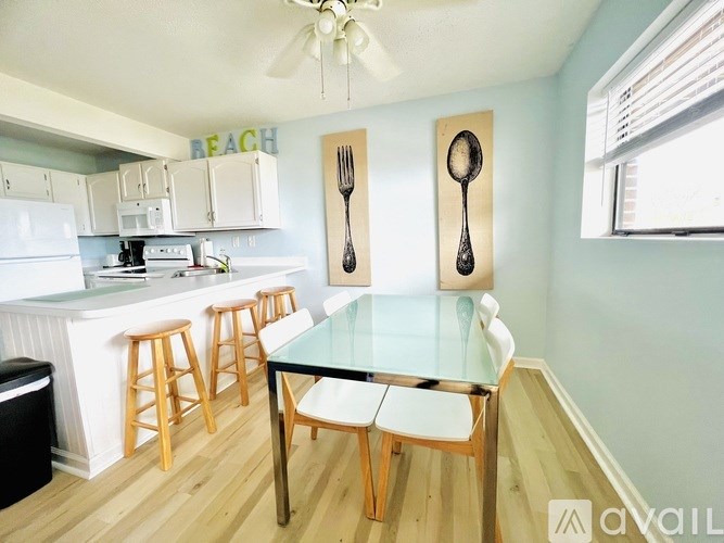 A kitchen with a table and chairs in the middle of it.