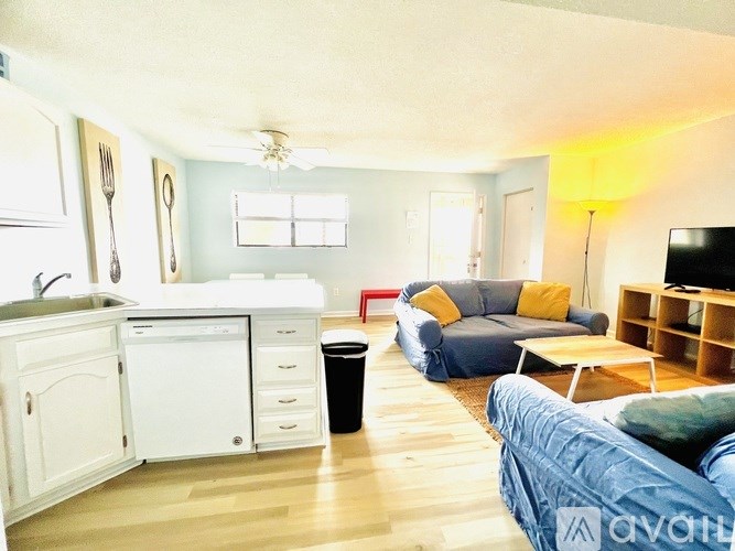 A living room with a blue couch and a television.