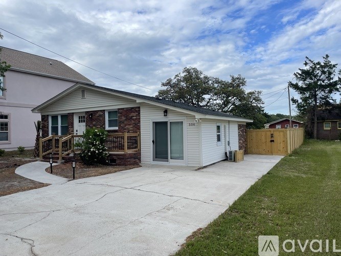 A house with a garage and a driveway in front.