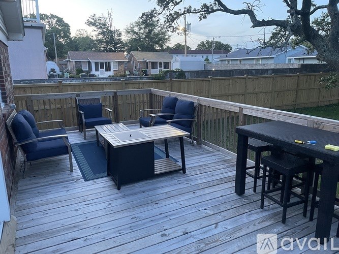 A wooden deck with a table and chairs.